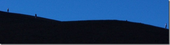 cropped closeup of people on Inferno Cone, a cinder cone at Craters of the Moon National Monument, Idah