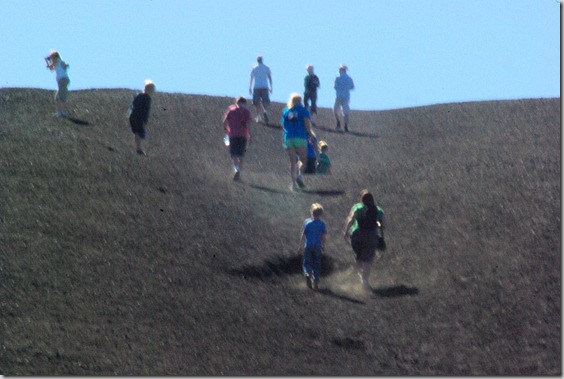 people nearing the top of Inferno Cone, a cinder cone at Craters of the Moon National Monument, Idah