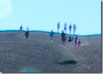 cropped closeup of people at the top of Inferno Cone, a cinder cone at Craters of the Moon National Monument, Idah