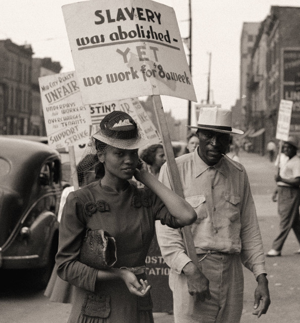 Picket line at Mid-City Realty Company, South Chicago, Illinois, July 1941 (Text in image: Slavery was abolished, yet we work for $8 a week)