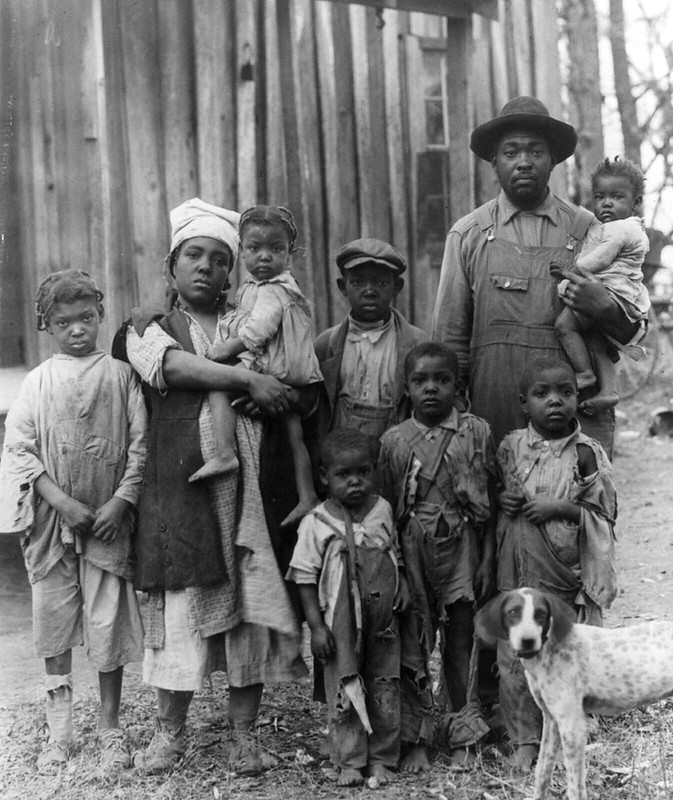 Red Cross relief, drought of 1930-31: Typical black American family of 9, destitute because of the drought, posed in front of house